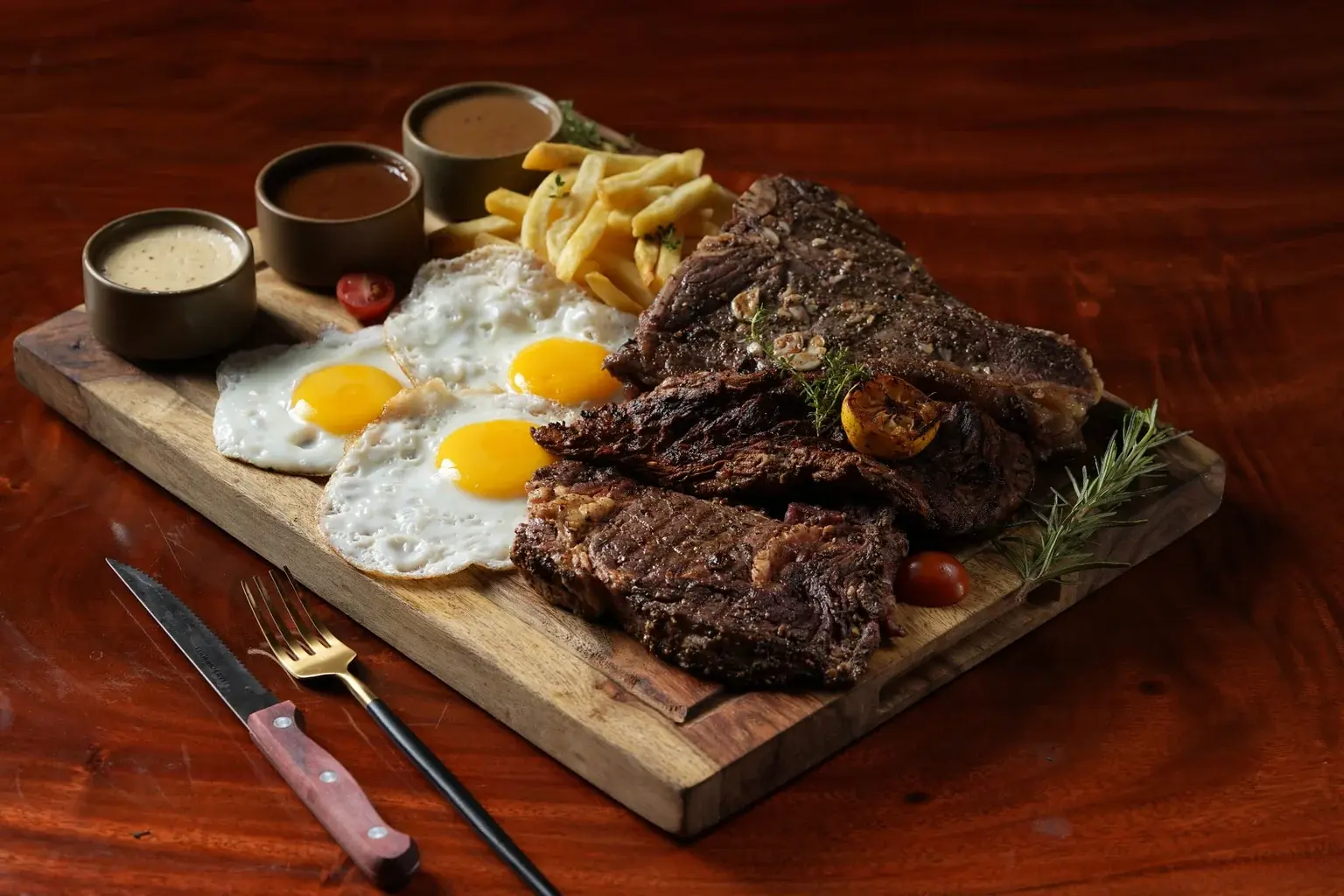 Ninan's steak served with sauce bowls and sides